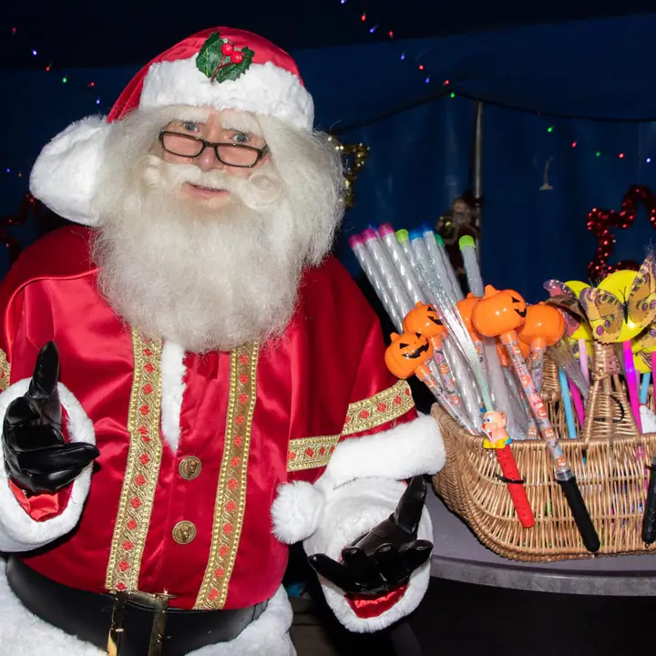 De Kerstman staat klaar met lekkers in de feestelijk versierde foyertent